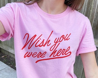 white shirt with pink writing