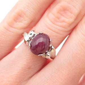 May include: A rustic wooden sign with the text "Welcome to our home" in white lettering. The sign features a distressed finish and a simple, inviting design, perfect for entryway decor.