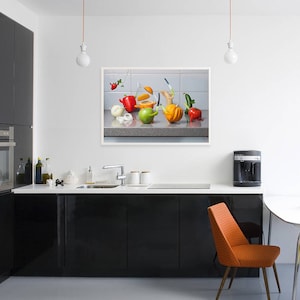 May include: A still life photograph of a kitchen counter with a variety of colorful fruits and vegetables arranged in a bowl. The fruits and vegetables include oranges, lemons, limes, apples, pears, and grapes. The bowl is made of ceramic and has a white glaze.