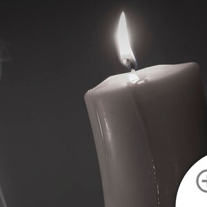 May include: A white candle with a flame burning at the top. Smoke is rising from the candle.