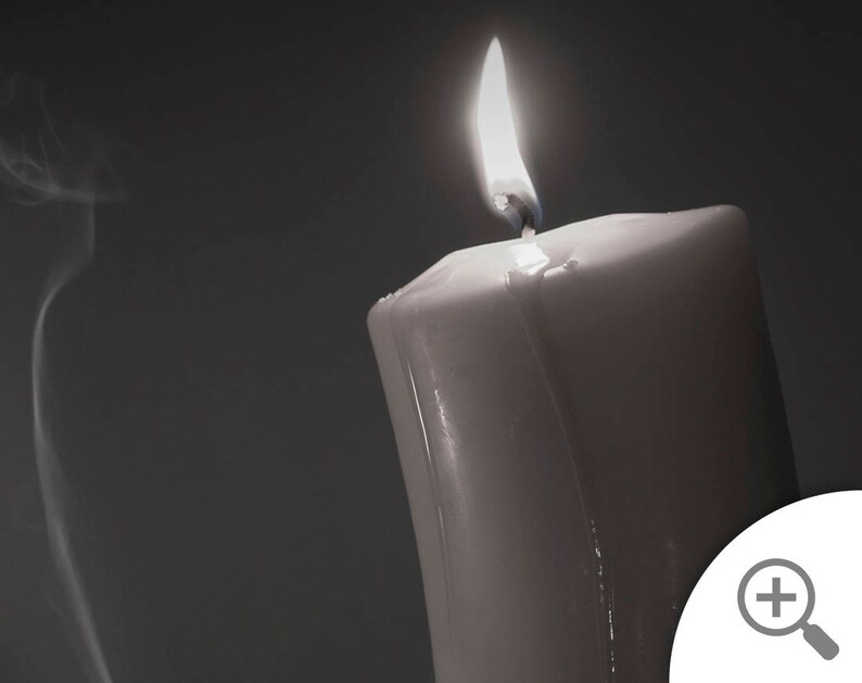 May include: A white candle with a flame burning at the top. Smoke is rising from the candle.