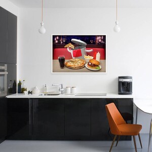 May include: A photograph of a kitchen featuring a framed picture of a pizza, a burger, and a glass of cola on a red and white checked tablecloth. The picture is hanging on a white wall above a black countertop with a sink and a coffee machine.