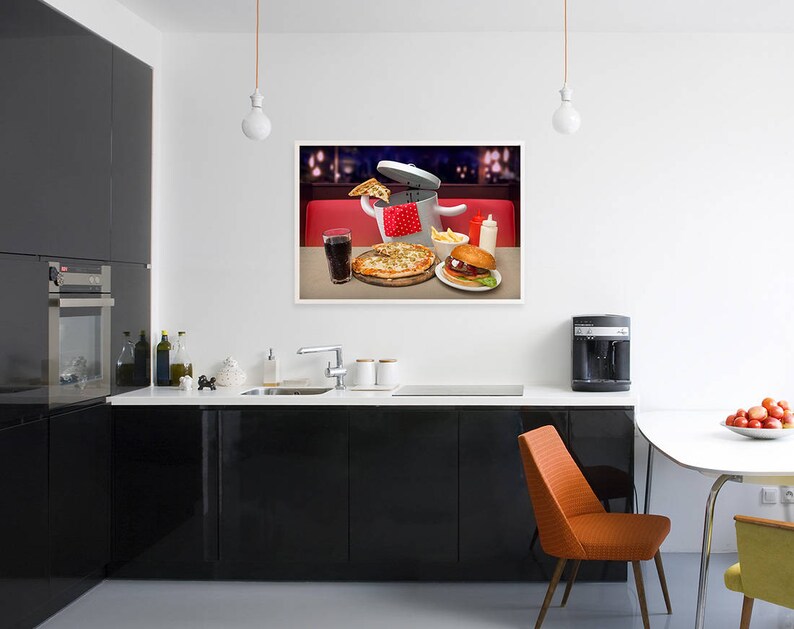 May include: A photograph of a kitchen featuring a framed picture of a pizza, a burger, and a glass of cola on a red and white checked tablecloth. The picture is hanging on a white wall above a black countertop with a sink and a coffee machine.