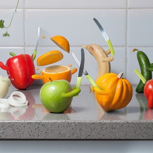 May include: A humorous still life featuring various fruits and vegetables with knives stuck in them. The scene includes a red bell pepper, a green apple, a yellow squash, a green cucumber, a red tomato, a banana, an orange, and a white onion.