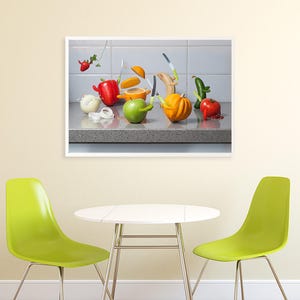 May include: A still life photograph of a variety of fruits and vegetables arranged on a countertop. The fruits and vegetables are arranged in a way that suggests they are being cut or sliced. The image is in a white frame.