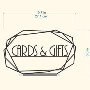 K&ouml;nnte beinhalten: Schwarzer geometrischer Rahmen mit dem Text "CARDS & GIFTS" in einer dekorativen Schriftart. Der Rahmen ist 17,2 cm hoch und 27,1 cm breit.
