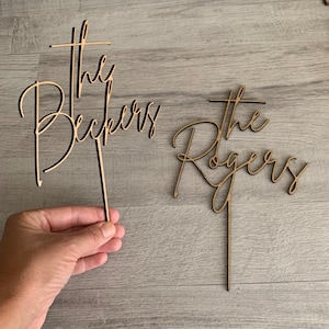 May include: A handmade wooden sign with the text "Welcome" in a playful font. The sign features a distressed white background and a dark brown frame, perfect for a front door or entryway.