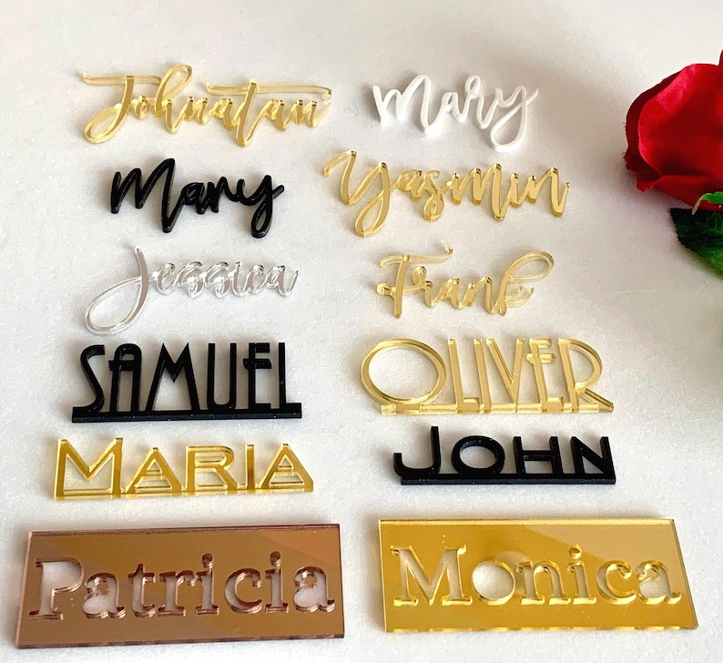 The first image shows personalized laser cut names in 6 different font styles and 5 color options, displayed together to compare the available designs and finishes.