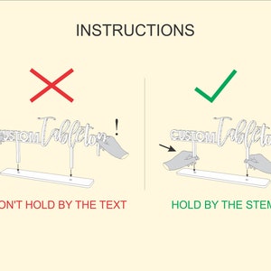 May include: Instructions on how to hold a custom tabletop sign. The sign says "CUSTOM Tabletop". A red X shows the incorrect way to hold the sign by the text. A green checkmark shows the correct way to hold the sign by the stems.
