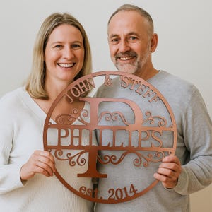 Personalized metal sign in copper color with your initial, surname, two firts names and established year. Cut from durable 16-gauge steel, and designed for easy hanging.