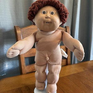 May include: A set of three ceramic mugs with a speckled, matte finish. The mugs are in shades of cream, light gray, and dark gray. Each mug has a simple, minimalist design and a rounded handle. Perfect for coffee or tea.