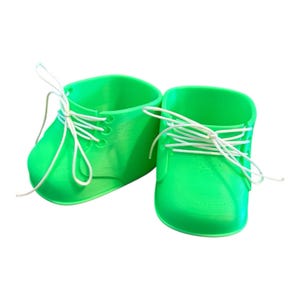 May include: A pair of vibrant green baby shoe-shaped planters. Each planter features white shoelaces and a classic shoe design. Ideal for small plants or succulents.