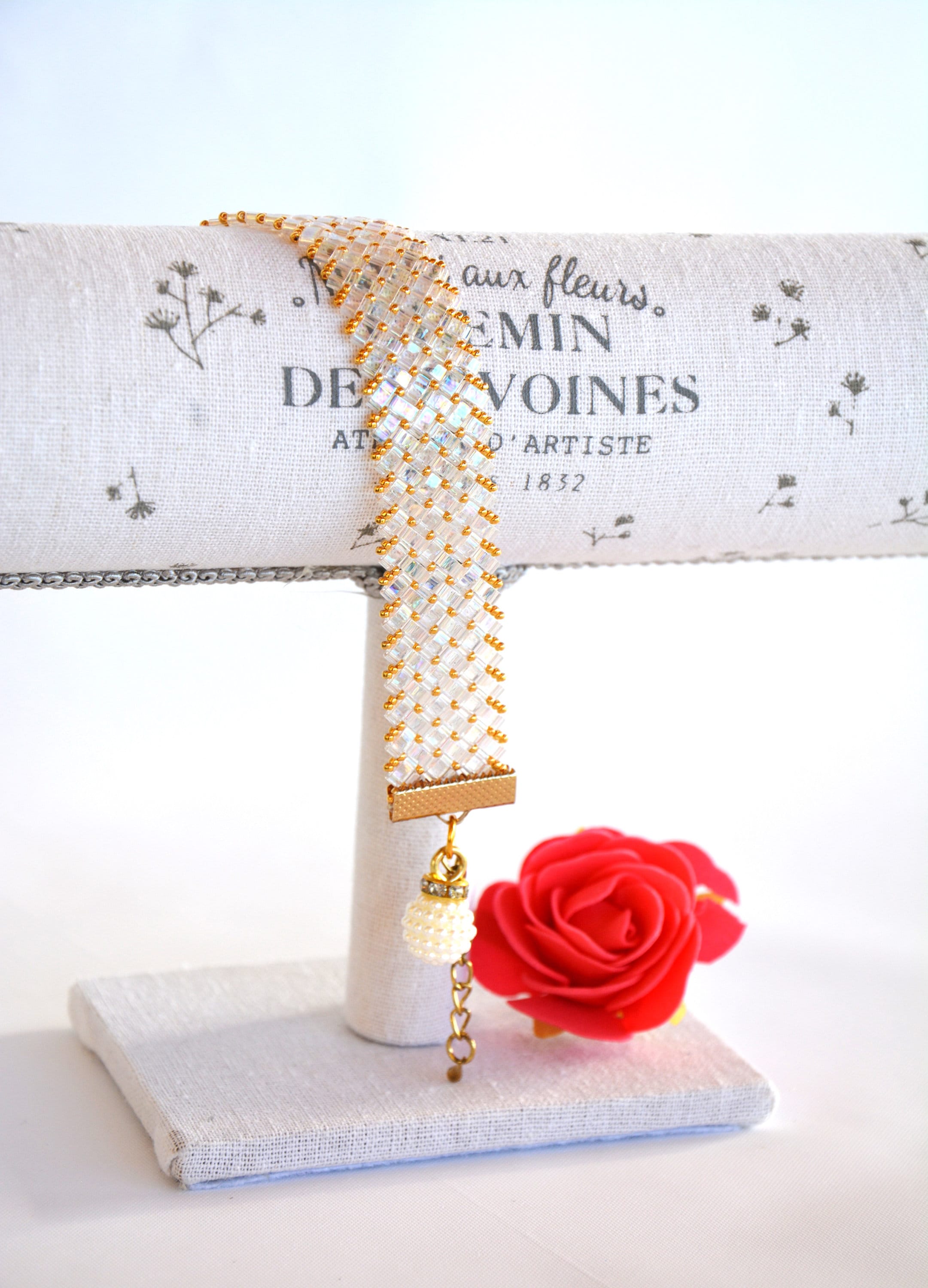 Transparent white bracelet with Half Tila beads and golden seed beads.