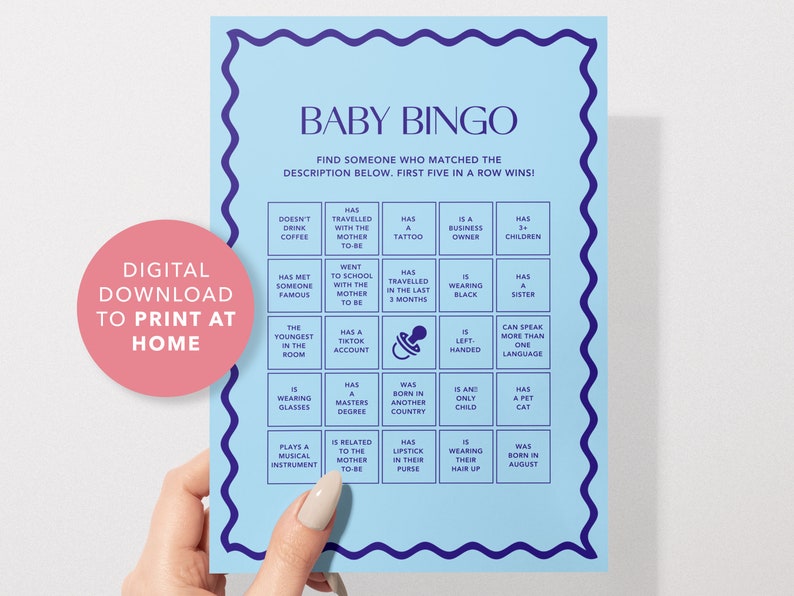 May include: A blue and white baby bingo card with a pacifier icon in the center. The card has 25 squares with different descriptions for guests to find at a baby shower.