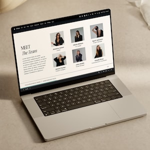 May include: A laptop screen displaying a website with a team of people. The website has a black and white design with the text "MEET The Team" at the top. The website also includes photos of the team members and their names and job titles.