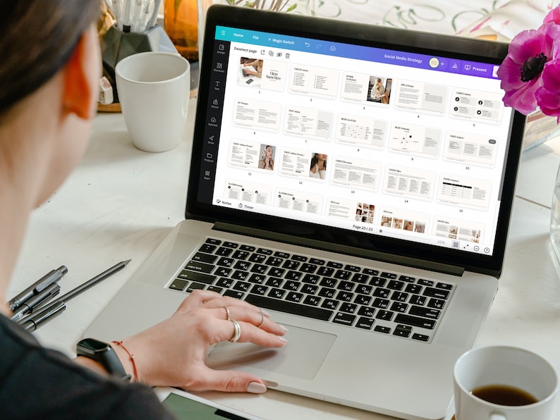 May include: A person working on a laptop computer with a white background. The laptop screen displays a document with the title "Social Media Strategy". The document is divided into sections with headings and text. The document is on page 23 of 23.