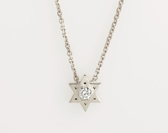 May include: A silver chain necklace with a small, silver Star of David pendant featuring a clear diamond in the center.