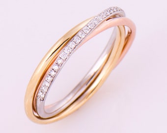 May include: A gold, silver, and rose gold intertwined ring with a row of small diamonds set in the band.