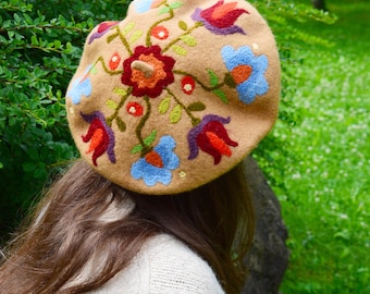 May include: A beige beret with colorful embroidered flowers. The flowers are in shades of red, orange, yellow, blue, and purple.