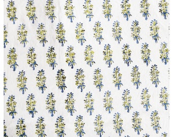 May include: White fabric with a repeating pattern of blue and green stylized floral designs.