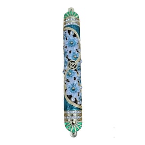 May include: A teal and gold mezuzah with white floral designs and rhinestones. The mezuzah has a green and gold top and bottom.
