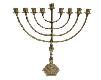 May include: A gold menorah with nine candle holders, a decorative base, and a traditional design.