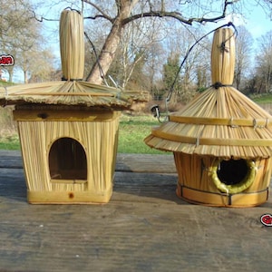 May include: Two birdhouses made of woven straw and bamboo. The birdhouses have a thatched roof and a small opening for birds to enter. The birdhouses are hanging from a string.