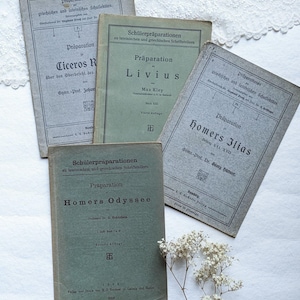 May include: Four vintage green and white paperbacks with German text. The books are titled "Präparationen", "Präparation Ciceros R", "Präparation Livius", and "Präparation Homers Odyssee".