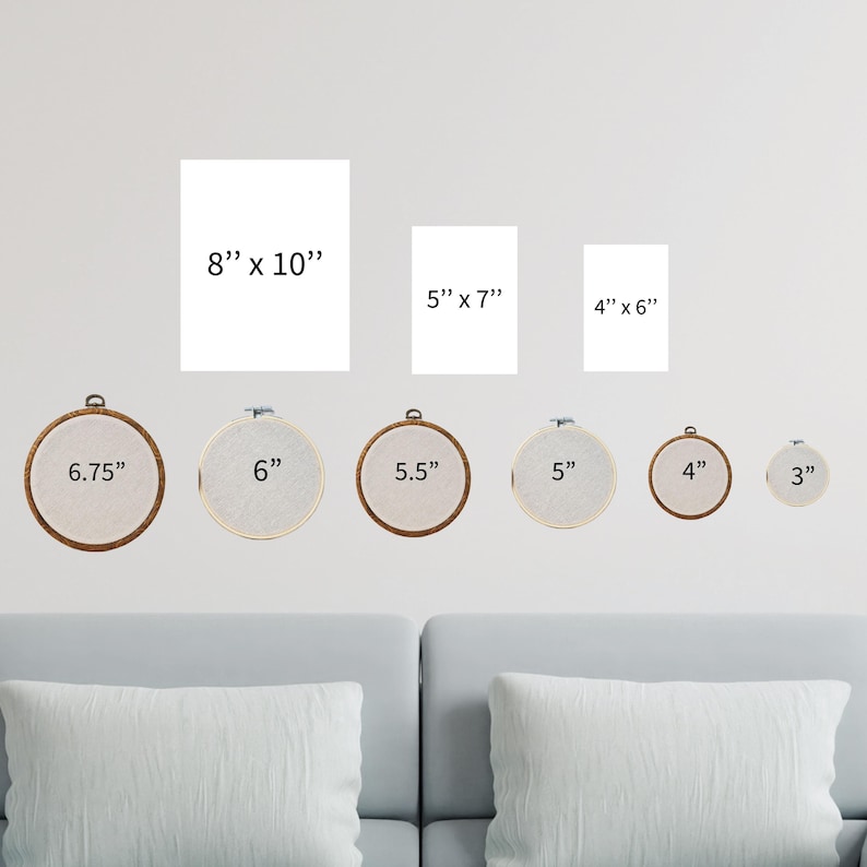 a living room with a couch and a set of cross stitch wall hangings