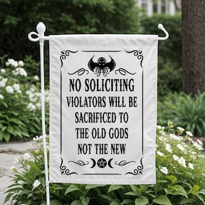 May include: White garden flag with black text and decorative elements. The flag reads "NO SOLICITING VIOLATORS WILL BE SACRIFICED TO THE OLD GODS NOT THE NEW." Features a stylized octopus and crescent moon design.