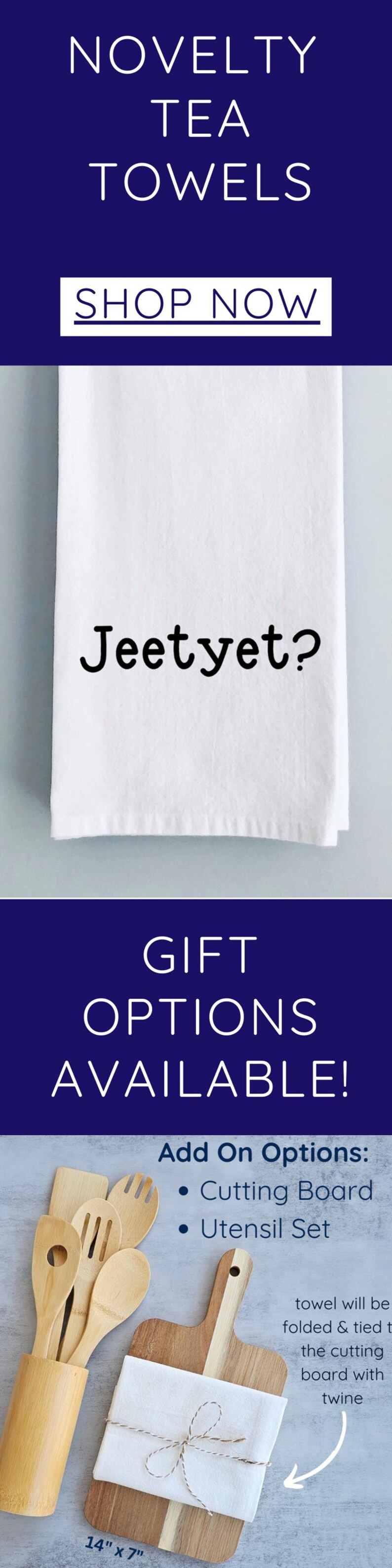 May include: White tea towel with the text "Jeetyet?" printed on it. The towel is folded and tied with twine around a wooden cutting board. The cutting board is 14 inches by 7 inches.  Add-on options include a cutting board and a utensil set.