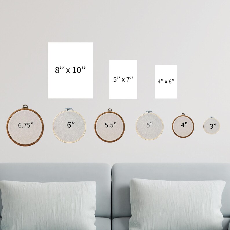 a living room with a couch and a set of cross stitch wall hangings