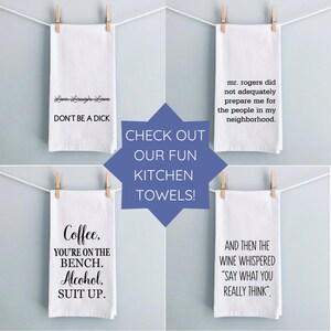 four kitchen towels hanging on a clothes line