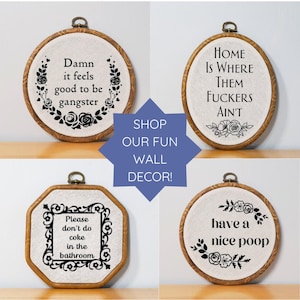 a set of four hand embroidered wall hangings