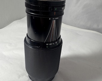 Vintage manual focus zoom camera lens, 70–210mm range, f/4–5.6, macro capable, classic SLR mount, tested used