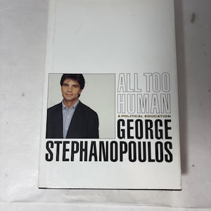Puede incluir: Un libro de tapa dura titulado "ALL TOO HUMAN" de George Stephanopoulos. La portada es predominantemente blanca, con un retrato del autor y texto negro.