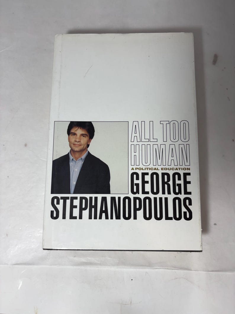 Puede incluir: Un libro de tapa dura titulado "ALL TOO HUMAN" de George Stephanopoulos. La portada es predominantemente blanca, con un retrato del autor y texto negro.