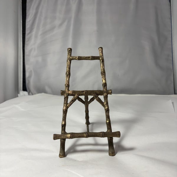 vintage-style, brass tabletop easel features a detailed faux bamboo design