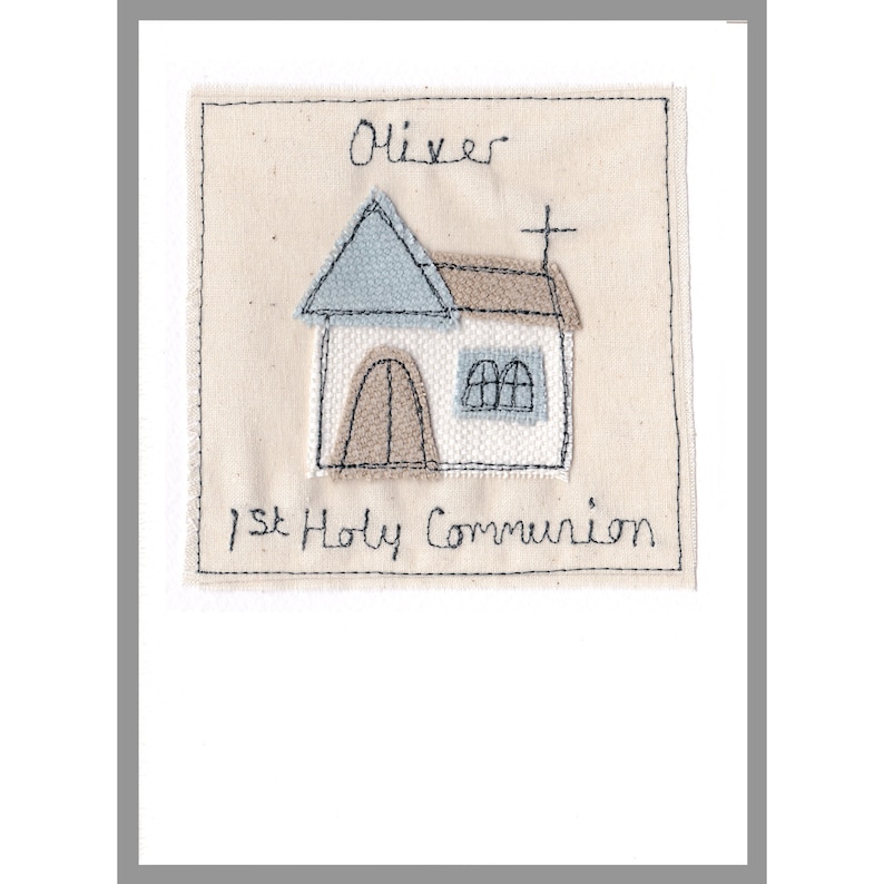 May include: A white card with a stitched design of a church with a cross on top. The card says "Oliver 1st Holy Communion" in black stitching.