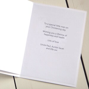 May include: A white card with a message wishing someone a happy Christening day. The card says "To a special little man on your Christening day. Wishing you a lifetime of happiness and health. Lots of love. Uncle Paul, Auntie Sarah and Ella xxx."