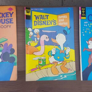 May include: Three vintage comic books featuring Walt Disney characters. The first comic book features Mickey Mouse and Goofy, the second features Donald Duck, and the third features Chip and Dale.