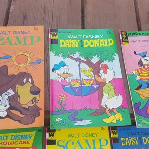 May include: A collection of vintage Walt Disney comic books featuring Scamp, Daisy and Donald, and Moby Duck. The covers are colorful and feature illustrations of the characters.