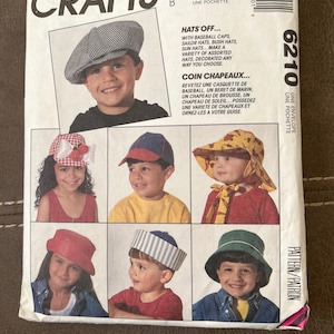 May include: McCall's Crafts pattern for making various hats, including baseball caps, sailor hats, and sun hats. The pattern features images of children wearing different hat styles. The text on the pattern reads "Hats Off..." and "Coin Chapeaux..."