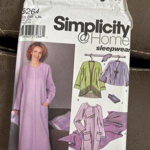May include: Simplicity @ Home sleepwear pattern 5264. The pattern features a long, light purple robe with pockets, and other sleepwear options. The package includes a photo of the finished robe and other sleepwear items.