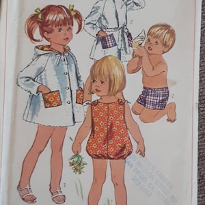 May include: A vintage Simplicity sewing pattern for children's clothing. The pattern is for a toddler size 3 and includes three different designs: a hooded jacket, a romper, and a pair of shorts. The pattern is titled "7040 Simplicity" and costs 50 cents.