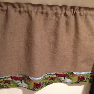 May include: A brown burlap valance with a red tractor and barn scene printed on the bottom edge.