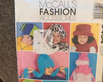 May include: A sewing pattern for making various children's hats. The pattern includes instructions for making a leopard print beret, a blue and white winter hat, a yellow beret with polka dots, a white beret with a fur trim, and a pink and white winter hat with mittens.