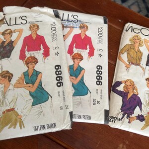 May include: Vintage McCall's sewing patterns featuring illustrations of blouses and tops. The patterns include the number 6866 and the price $2.00. The bust sizes are 32 1/2 and 24. The patterns are for Misses sizes.