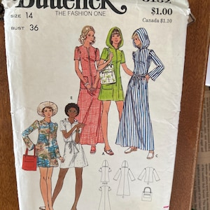 May include: A vintage Butterick sewing pattern envelope, size 14, bust 36, featuring illustrations of five different dress styles. The designs include a red checkered maxi dress, a green hooded mini dress, a blue striped hooded maxi dress, a tropical print mini dress, and a white collared mini dress.