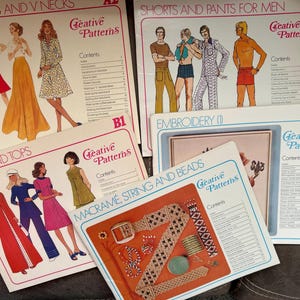 May include: A collection of vintage sewing pattern books with illustrations of clothing designs. Titles include "Skirts and V Necks", "Shorts and Pants for Men", "Pants and Tops", "Embroidery", and "Macrame, String and Beads". The books have a retro aesthetic.